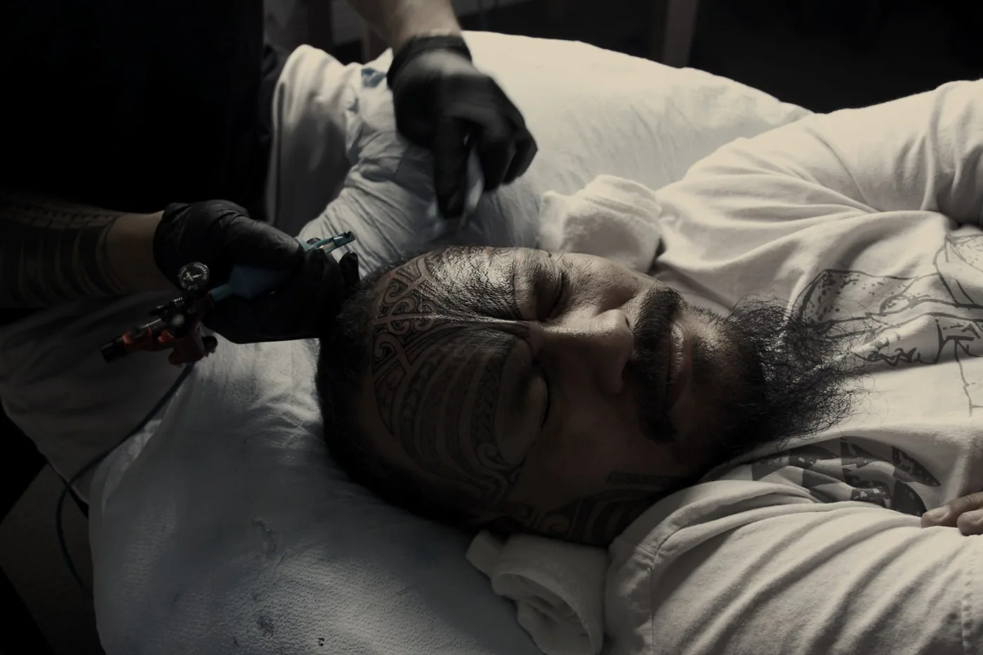 The sacred tatau artist tattooing a facial moko onto the Ali'i Nui in Aotearoa